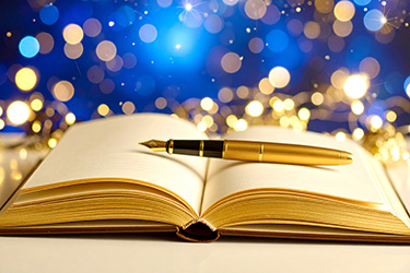 An open book with a fountainpen across its pages