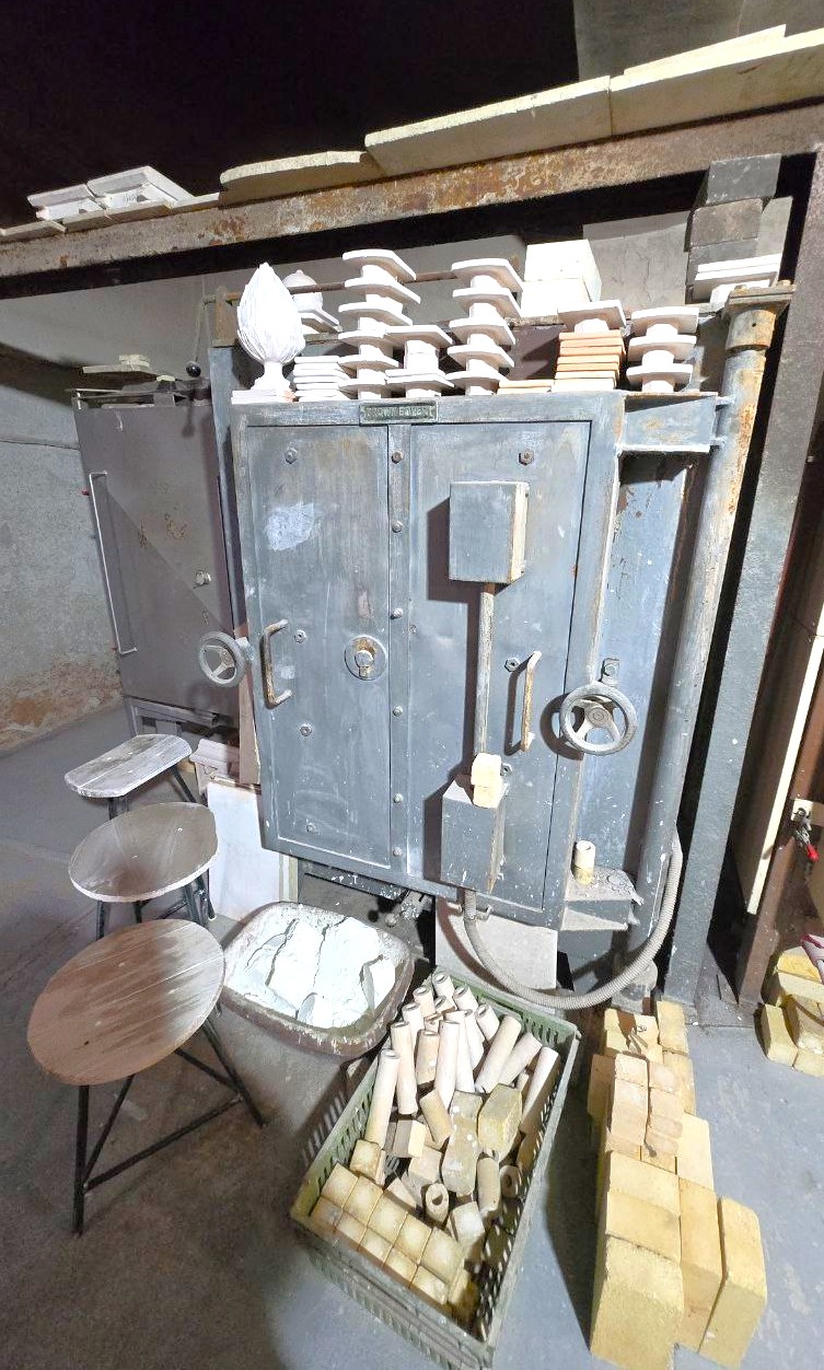 A Kiln Surrounded by Raw Tiles and Fireclay Bricks