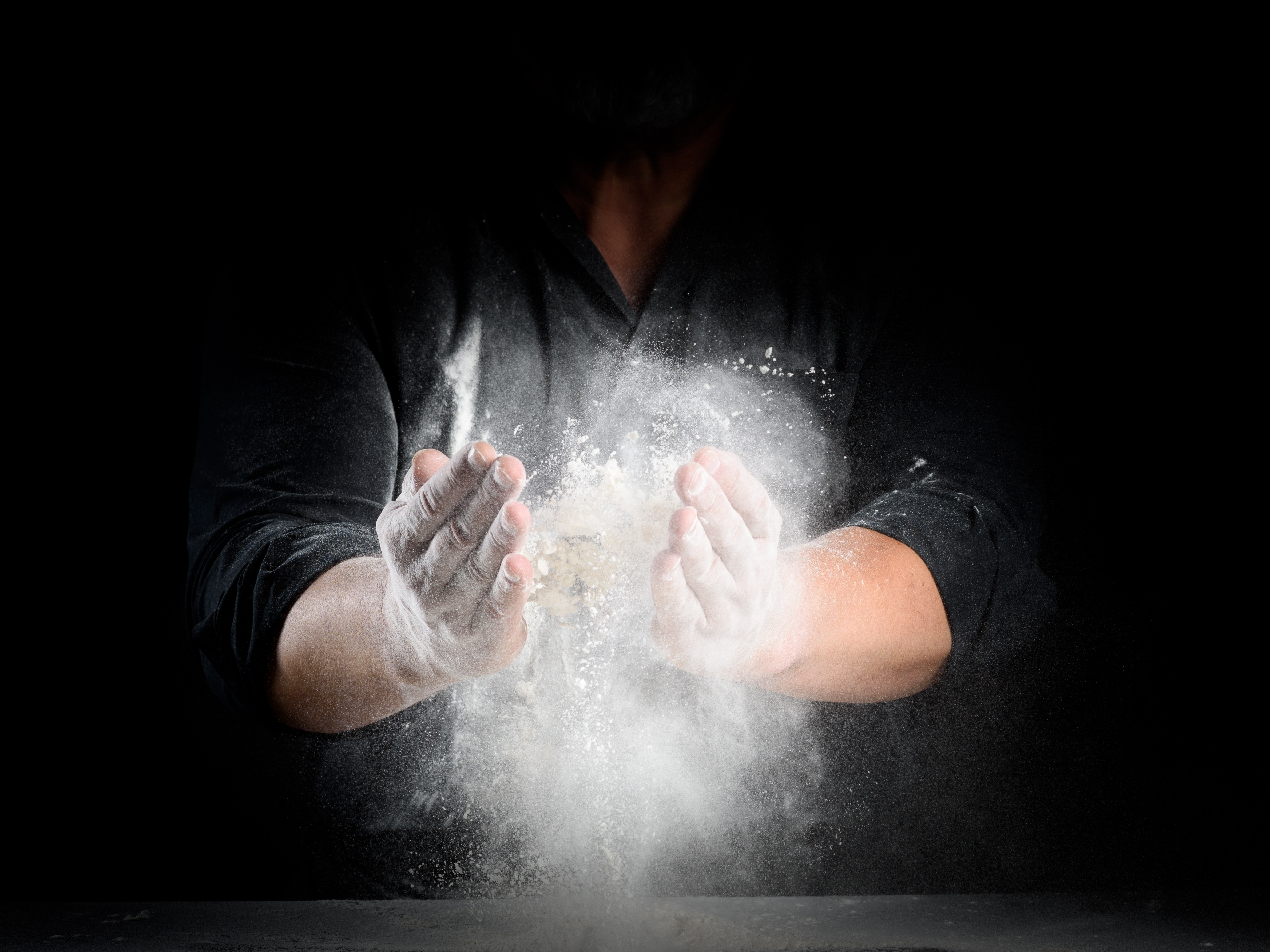 Hands working with flour.